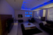 Feature Ceiling bulk head with blue led light and feature back wall.