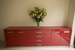 Red gloss side board with centre drawer stainless steel bottom.